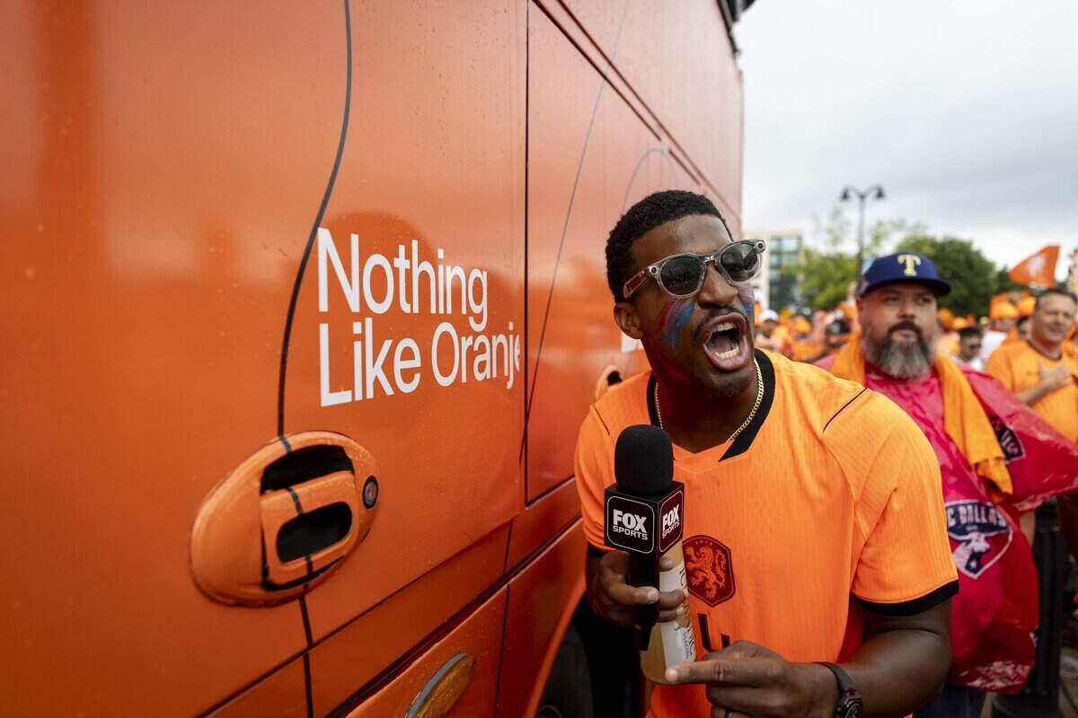 New York Giants quarterback Jameis Winston makes an appearance ahead of the orange fan walk on Sunday, June 14, 2026 in Arlington, Texas. The famous double-decker Dutch Orange Bus, or De beroemde Oranjebus, is part of a Netherlands fan tradition bringing a sea of orange to the streets before major soccer matches.