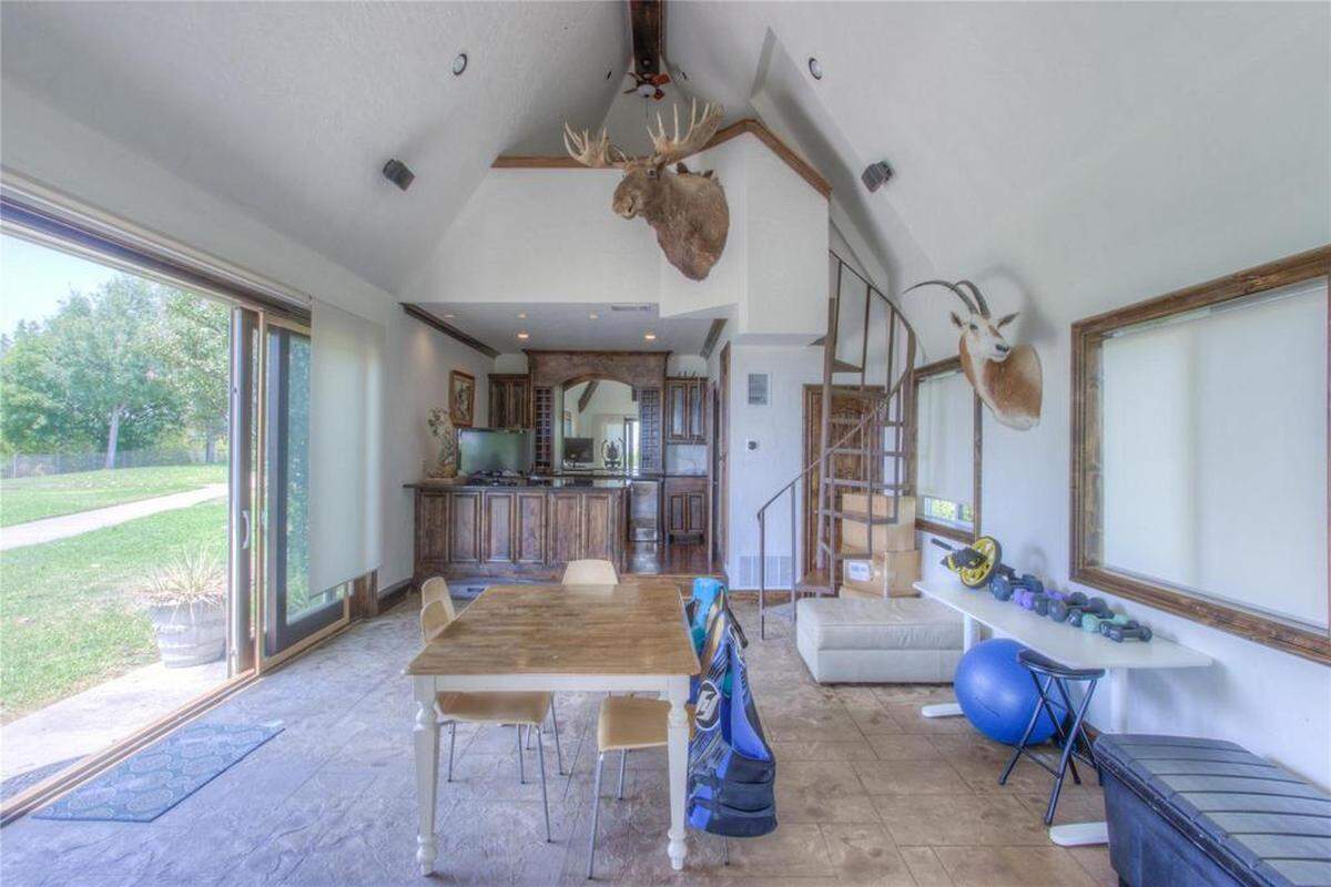 The pool house acts as another guest space with a kitchenette, loft bedroom, and bathroom.