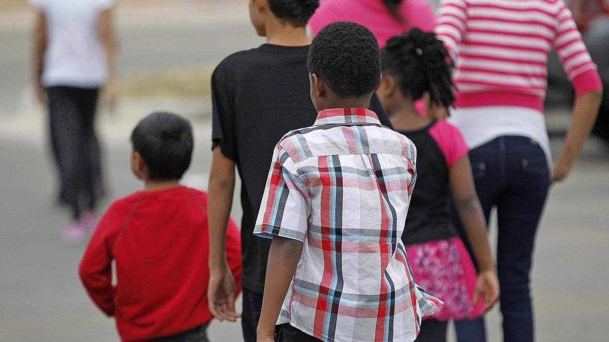 Undocumented children return from recess at Catholic Charities Fort Worth on February 19, 2014, in Fort Worth, Texas. Catholic Charities works with the government to shelter undocumented youngsters apprehended at the Texas/Mexico border. It also assists in resettling refugees from around the world.