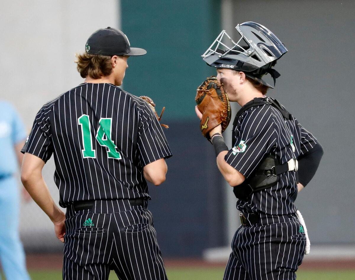 Carroll pitcher Griffin Herring (14) and catcher Clark Springs (6) talk on the mound during a UIL 6A Region I bi-district playoff baseball game at Carroll Senior High School in Southlake, Texas, Thursday, May 05, 2022. Carroll defeated Bell to move on to the area round. (Special to the Star-Telegram Bob Booth)