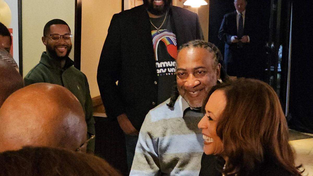 Kamala Harris, standing with Erie County Councilman Andre Horton, shakes hands with local Black business owners at Legenderie Records and Coffee House on Oct. 14, 2024.