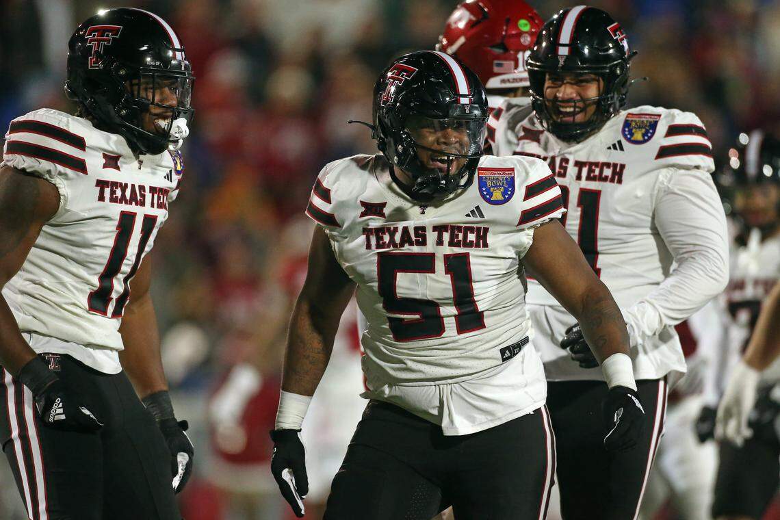 Dec 27, 2024; Memphis, TN, USA; Texas Tech Red Raiders linebacker Charles Esters III (11) and defensive linemen Jayden Cofield (51) react after a tackle for loss during the second quarter against the Arkansas Razorbacks at Simmons Bank Liberty Stadium. Mandatory Credit: Petre Thomas-Imagn Images
