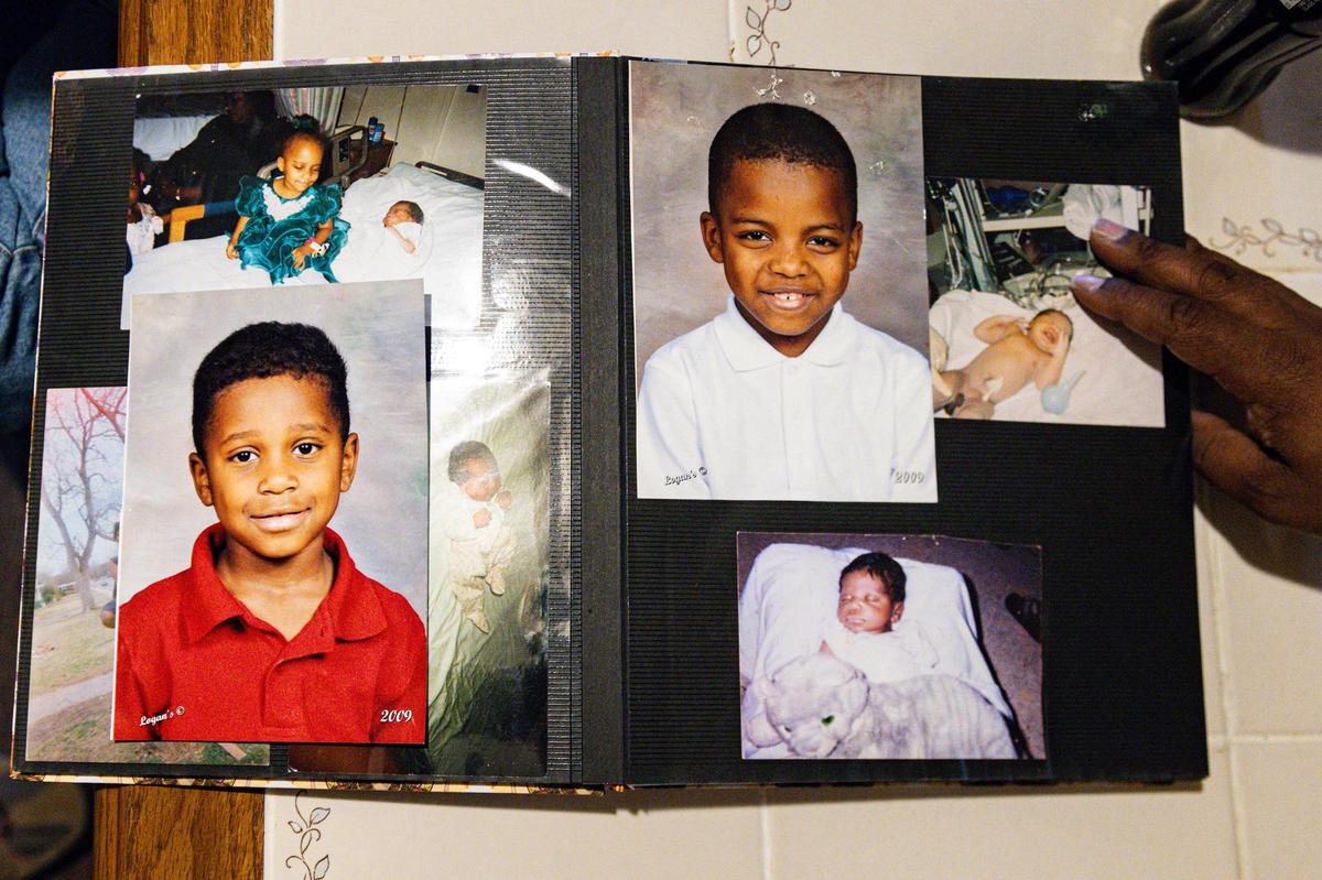 Salillian Parker, the mother of Daniel Reed, shows photos of her sons in a photo book at her home in Fort Worth on Aug. 28.
