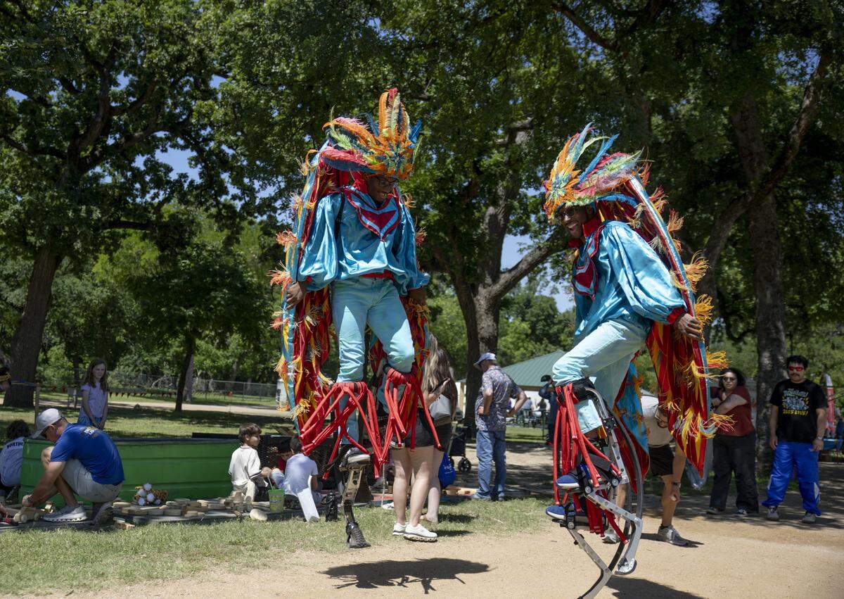 Michael Johnson and Justin Chatman walk around Mayfest on bounce stilts on Saturday, May 2, 2026, in Fort Worth, Texas. The festival started on Thursday, April 30 and runs through Sunday, May 3. 