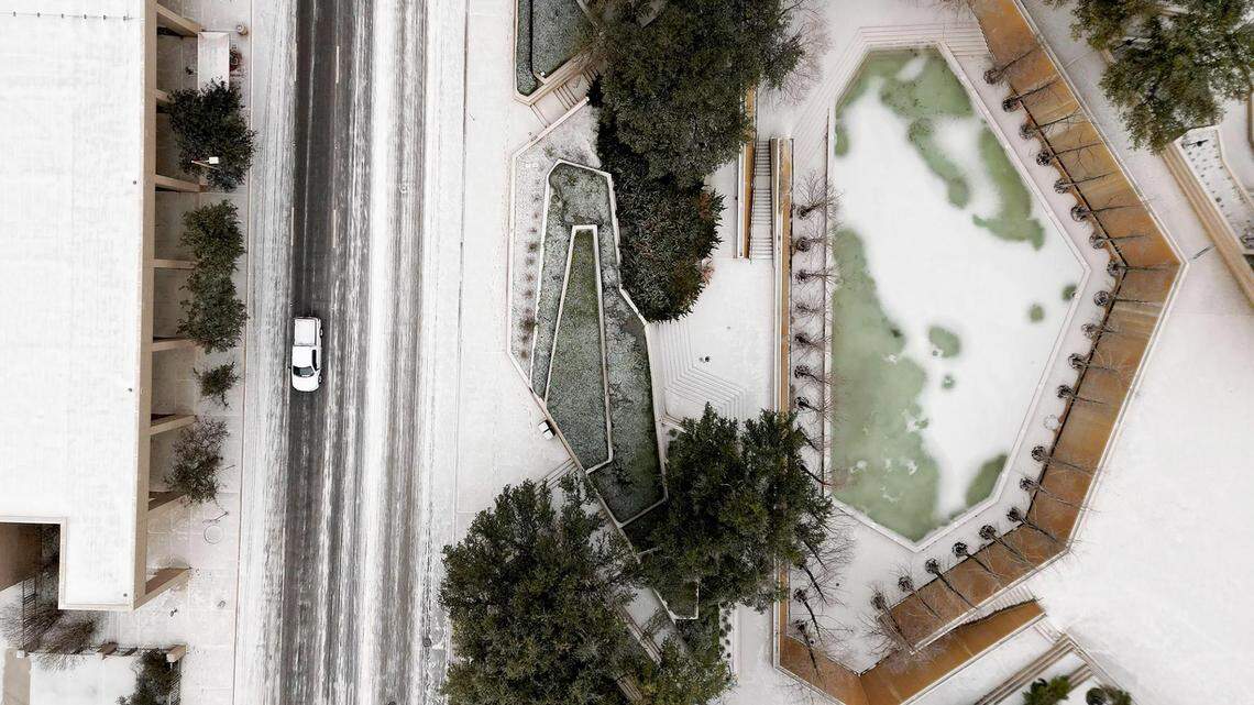 A thin layer of snow coats the Water Gardens and Commerce Street in downtown Fort Worth on Monday, January 15, 2024.