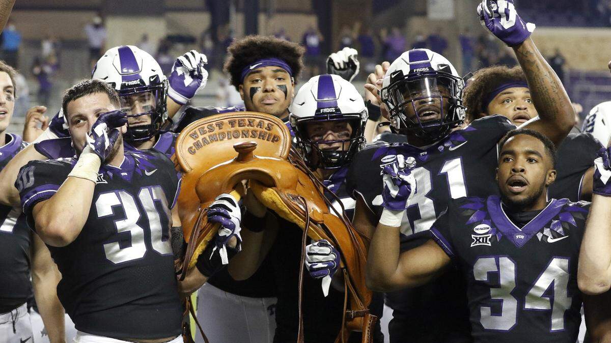 TCU players hold the Saddle Trophy after defeating Texas Tech in a NCAA college football game at Amon G. Carter Stadiumon Nov. 07, 2020. TCU hopes to collect the trophy again on Saturday. (Special to the Star-Telegram Bob Booth)