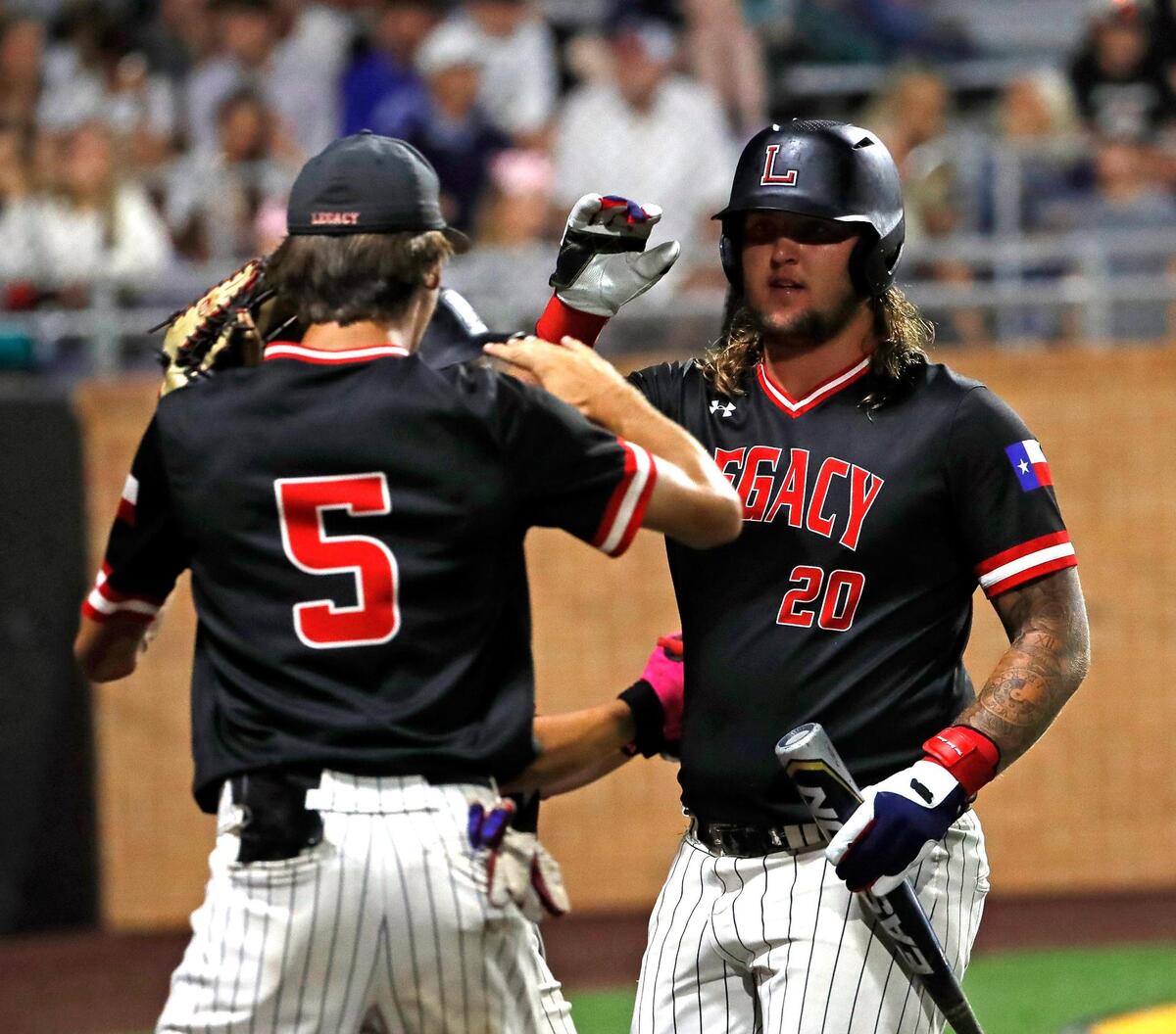 Legacy left fielder JT Longino (5) and first baseman Kayden Voelkel (20) high five each other during game one of a 5A Region I final baseball game at Cleburne High School, Texas, Friday, June 03, 2022. Legacy defeated Aledo 8-5 in the first game of a best of three series. (Special to the Star-Telegram Bob Booth)