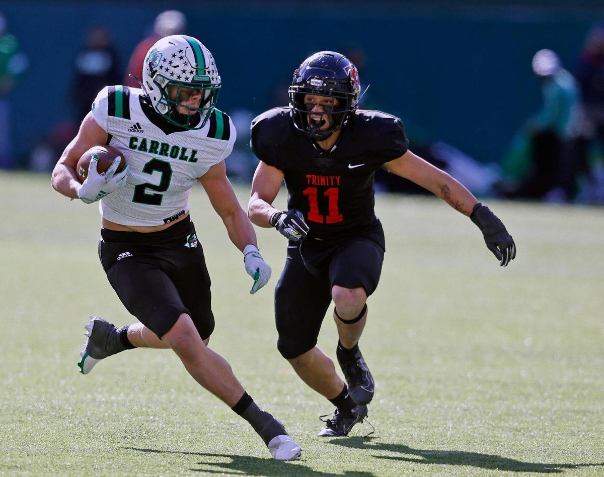 Southlake’s Owen Allen is chased by Trinity linebacker Sateki Wolfgramm (11) during the 6A division 1 quarterfinals at Globe Life Park in Arlington, Texas, Saturday, Jan. 02, 2021. Southlake defeated Trinity 59-35. (Special to the Star-Telegram Bob Booth)