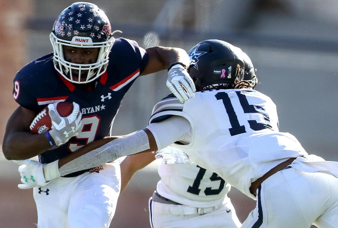 Denton Ryan running back Emani Bailey (9) tries to elude Frisco Lone Star linebacker Toren Pittman (15) during the first half of the 5A Division I State semifinal high school football playoff game played at Eagle Stadium in Allen, TX, Saturday, December 14, 2019.