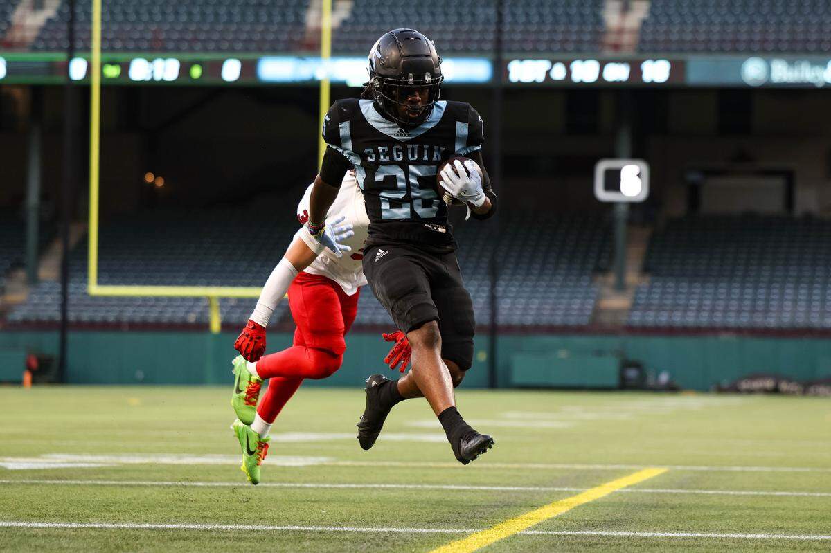 Arlington Seguin running back Ka'Darrius Trotter runs and leaps to the goal line past a Burleson Elks defender that resulted in a touchdown in the first quarter of a non-district game between Arlington Seguin and Berleson at Choctaw Stadium on Sept. 11, 2025.