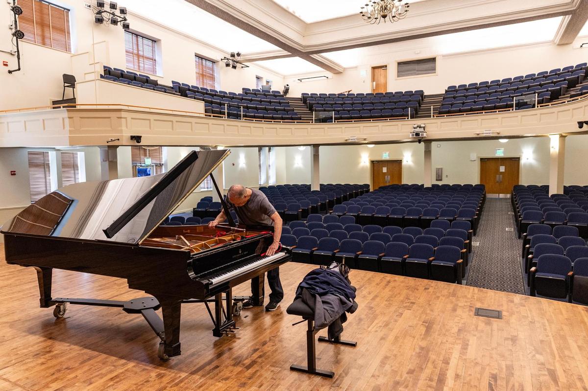 Piano tutor Robin Hufford tunes a piano on stage at Nicholas Martin Hall on the Texas Wesleyan University campus in Fort Worth on Tuesday, April 8, 2025.