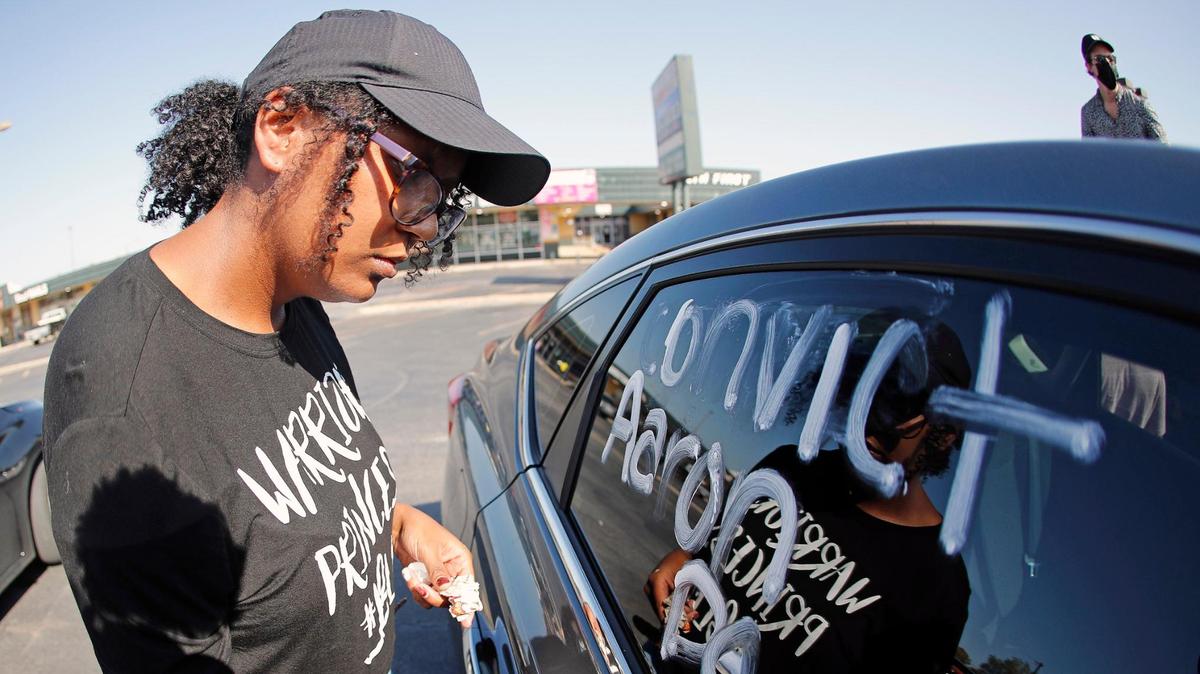Octavia Woodard asks for the conviction of Aaron Dean, the Fort Worth police officer who shot Atatiana Jefferson, during a memory parade and vigil for Jefferson in Fort Worth, Texas, Sunday, Oct. 11, 2020. Jefferson was killed by a Fort Worth police officer during a wellness check Oct. 12, 2019.