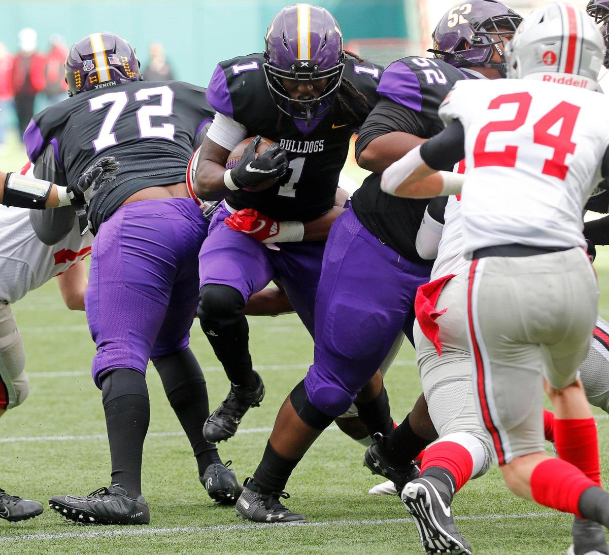 Everman’s Juan Davis (1) squeezes between his linemen during a Conference 5A Division 2 area round football playoff game at Globe Life Park in Arlington, Texas, Friday, Dec. 18, 2020. Lovejoy led Everman 28-7 at the half. (Special to the Star-Telegram Bob Booth)