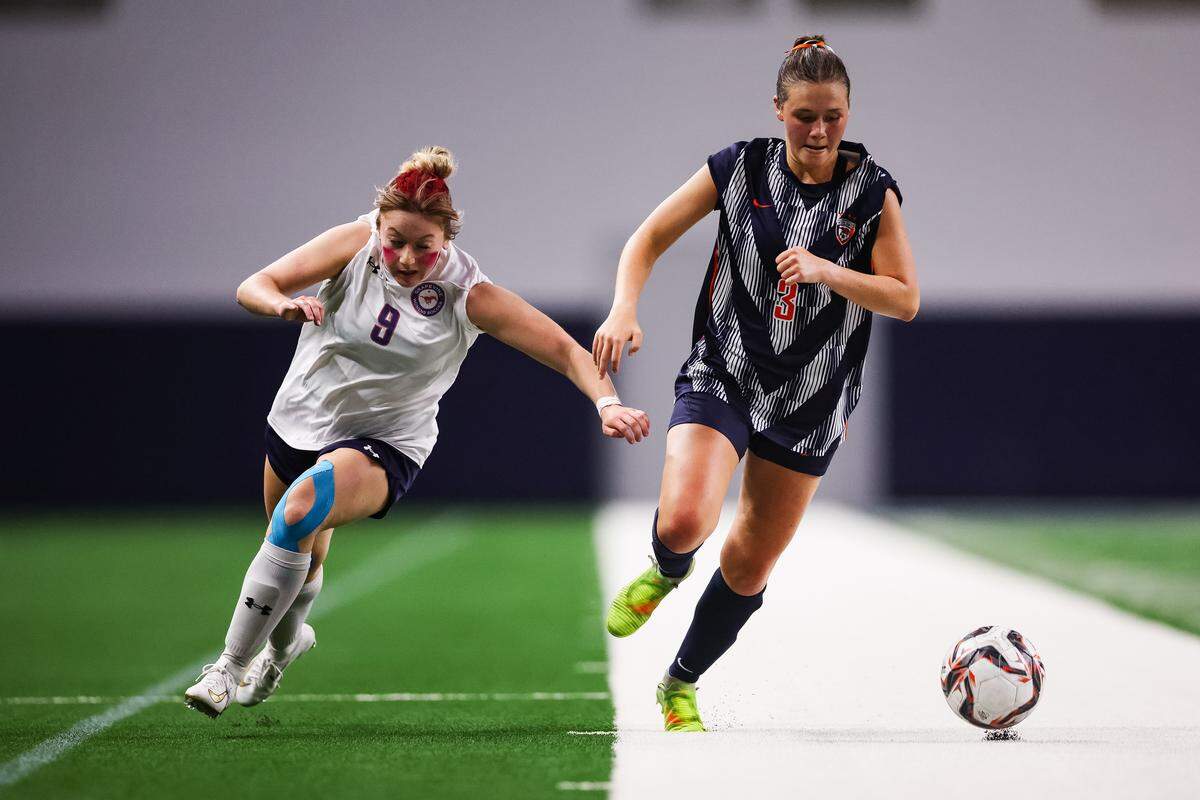 Grapevine forward Maddison Patton (9) runs side-by-side with a Frisco Wakeland defender in a Class 5A Division II UIL girls soccer state semifinal at the Ford Center on April 3, 2026 in Frisco, Texas.