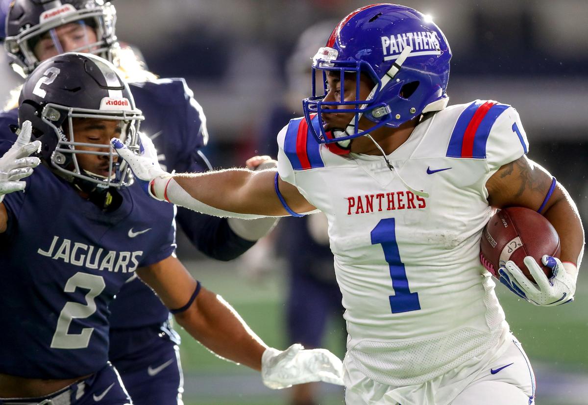 Duncanville running back Trysten Smith (1) gives a stiffarm to Flower Mound cornerback Josh Johnson (2) after a big gain during the first half of their 6A Division I area round high school football playoff game at AT&T Stadium in Arlington, Tx Saturday November 23, 2019.