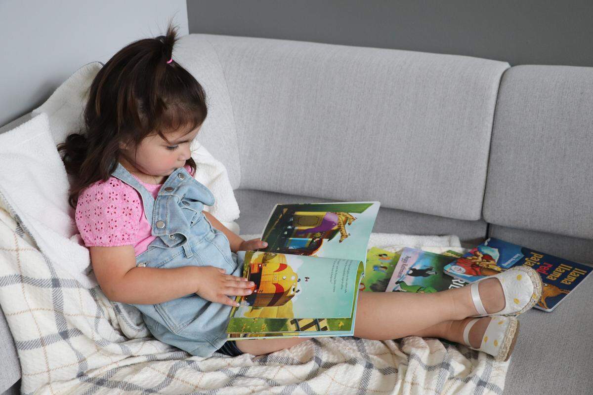 A Tarrant County child is pictured reading a book from Dolly Parton’s Imagination Library.