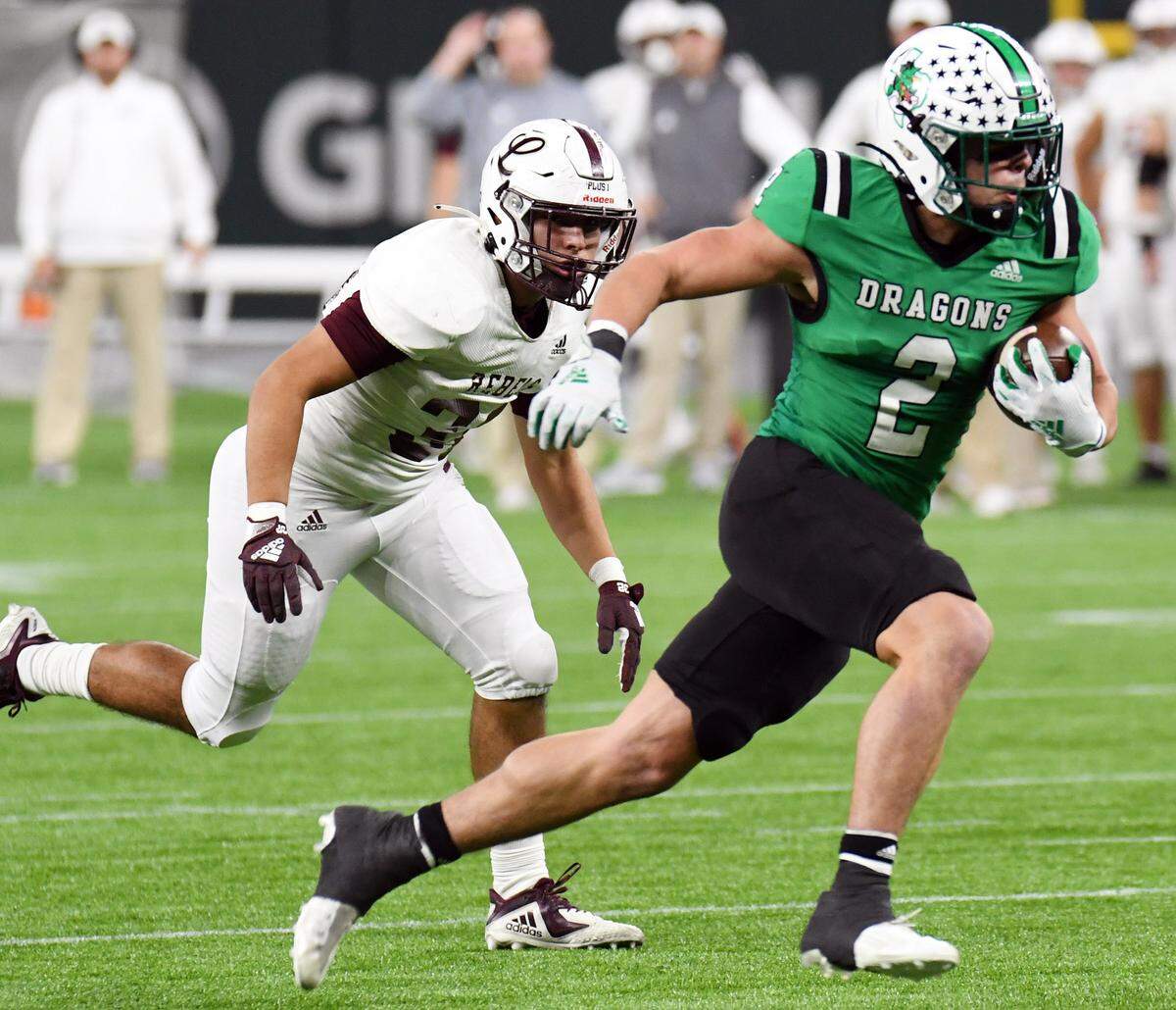Midland Legacy’s Abraham Davalos, left, chases Southlake Carroll’s Owen Allen as he breaks into the open field for a 23 yard touchdown run for a 6-0 lead in the first quarter of their Class 6A Division 1 Area football game Saturday, November 20, 2021 at Globe Life Field in Arlington, Texas. Special/Bob Haynes