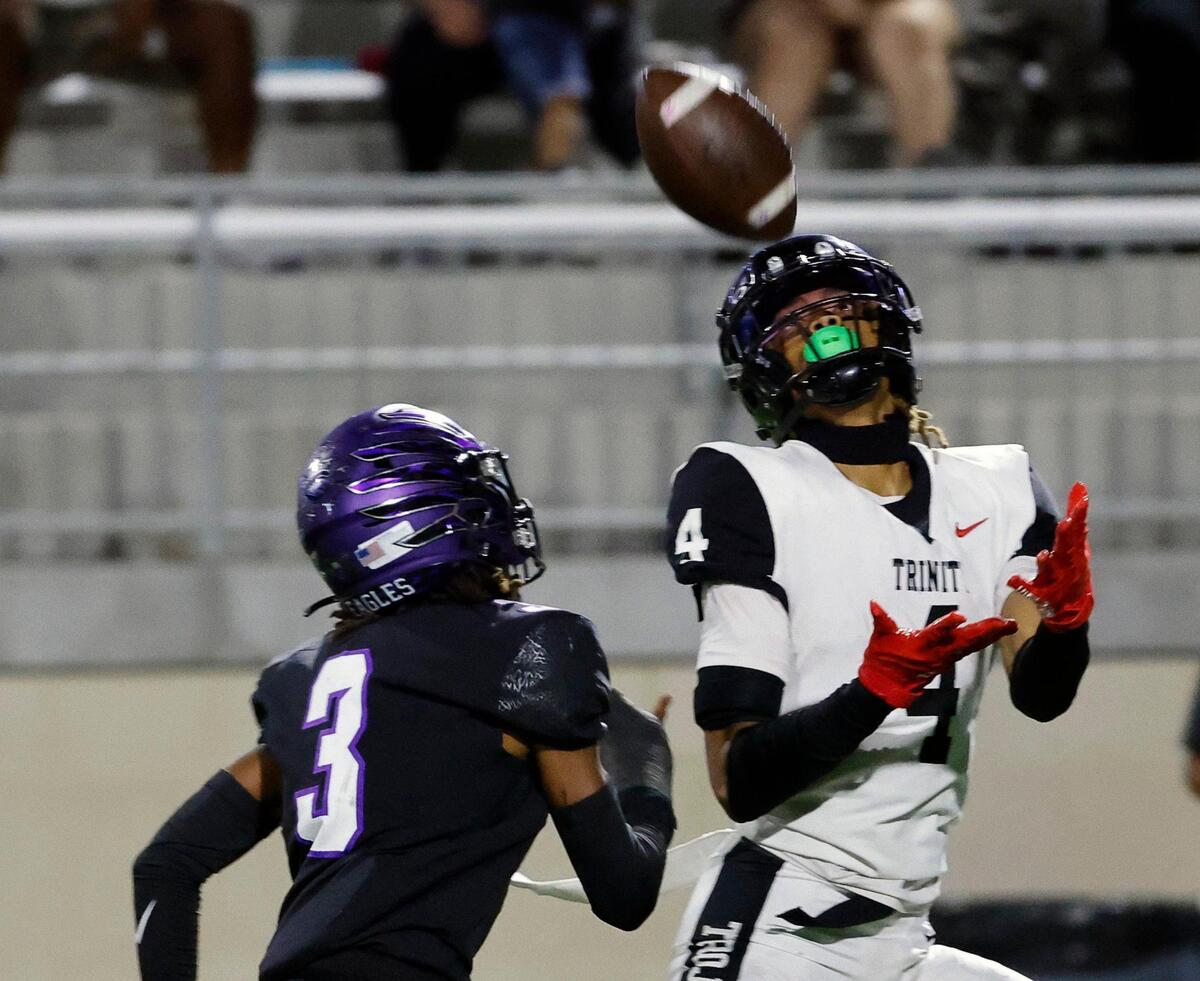 Trinity wide receiver Jarvis Heimuli (4) grabs a touchdown pass in front of Crowley corner back Ja’Corian White (3) to put the Trojans up 28-20 in the first half of a UIL high school football game at Crowley ISD Multi-Purpose Stadium in Crowley, Texas, Friday, Oct. 20, 2023.