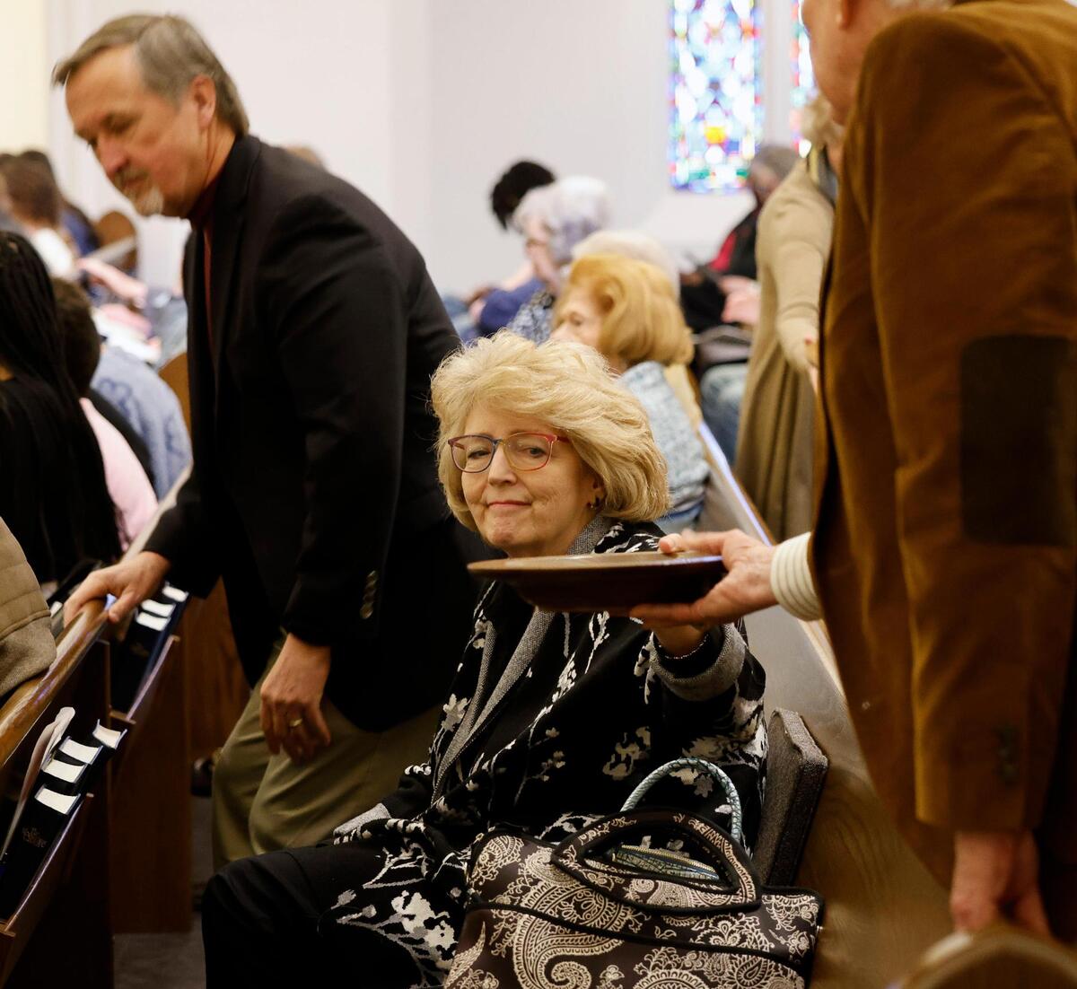 When Broadway Baptist established its justice committee, Katherine Godby, was selected the chair, a role she held for six months. She’s passing the plate during a recent service.