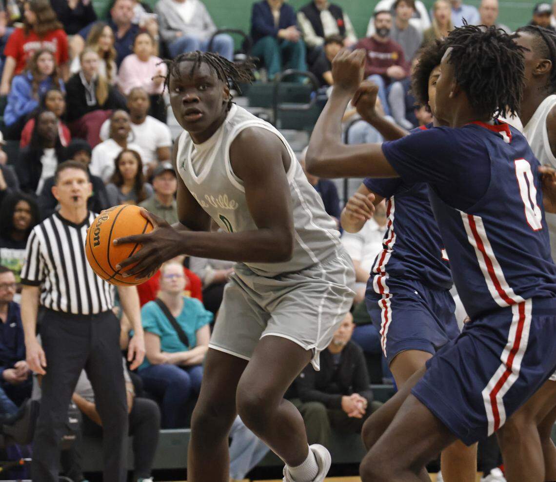 Birdville forward Gabriel Zachariah (0) gets a look in the corner defended by Denton Ryan forward Brandon Hawkins (0) during the first half of a UIL basketball game at Birdville High School in North Richland Hills, Texas, Tuesday Feb. 17, 2026.