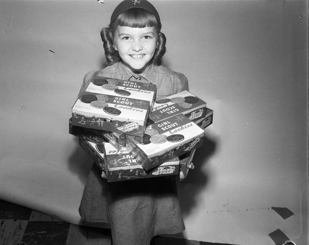 April 11, 1950: Deanna Olson, an 8-year-old Brownie at Circle Park Elementary School in Fort Worth, sells Girl Scout Cookies.