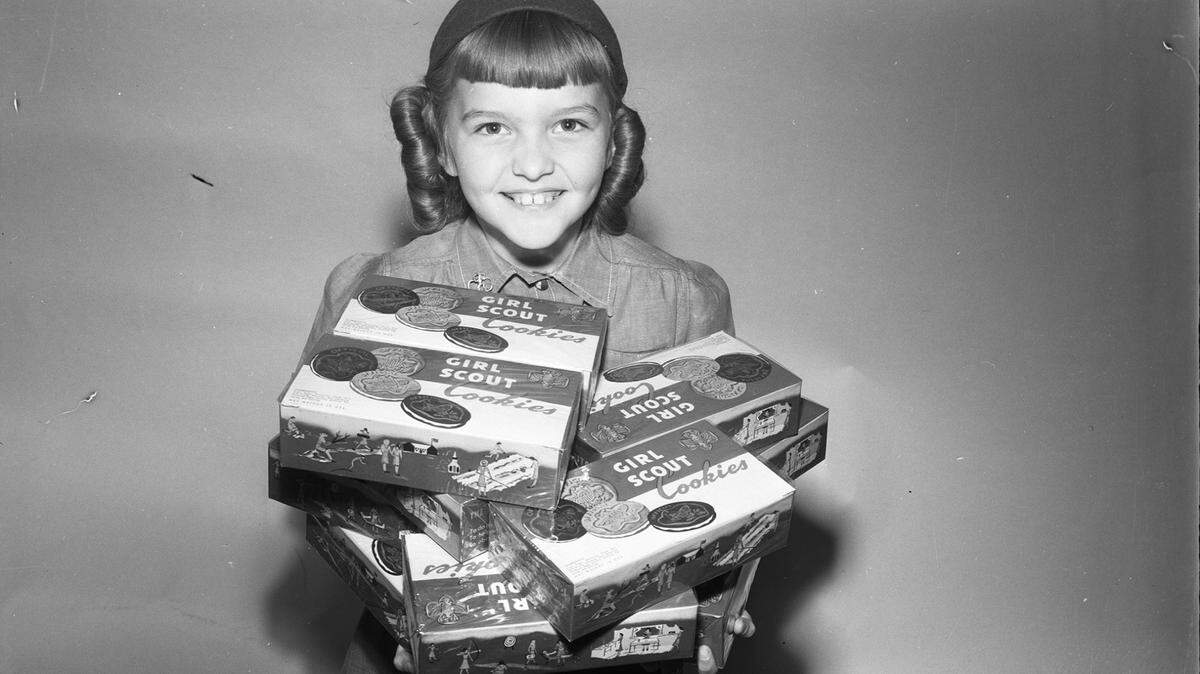 April 11, 1950: Deanna Olson, an 8-year-old Brownie at Circle Park Elementary School in Fort Worth, sells Girl Scout Cookies.