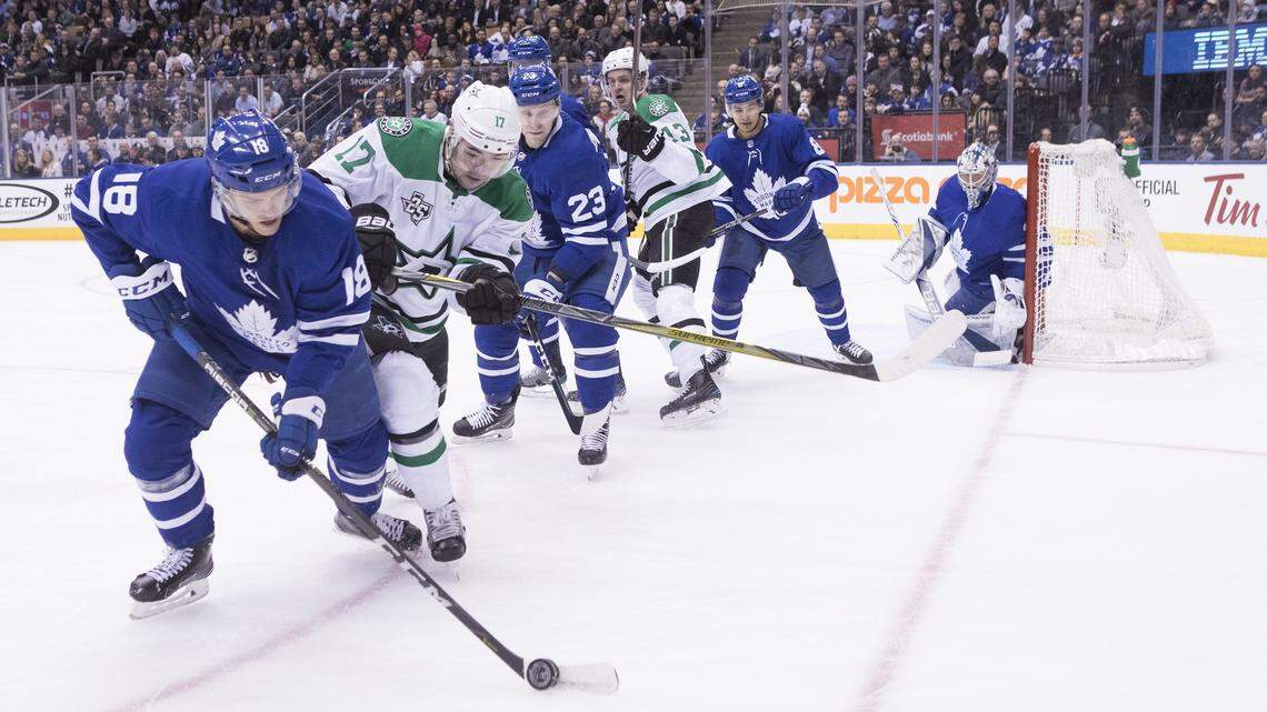 Toronto Maple Leafs left wing Andreas Johnsson (18) brings the puck away from Dallas Stars center Devin Shore (17) as a host of other players watch interestedly in the first period of Wednesday's game in Toronto.