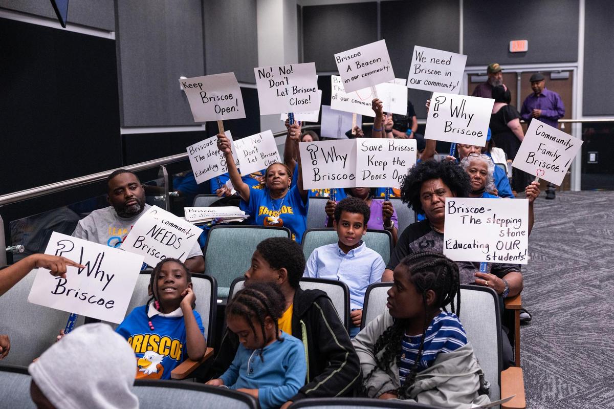 Parents and students in support of keeping Briscoe Elementary open hold signs during a FWISD School Board Meeting at the District Administration Building in Fort Worth on Tuesday, May, 20, 2025.