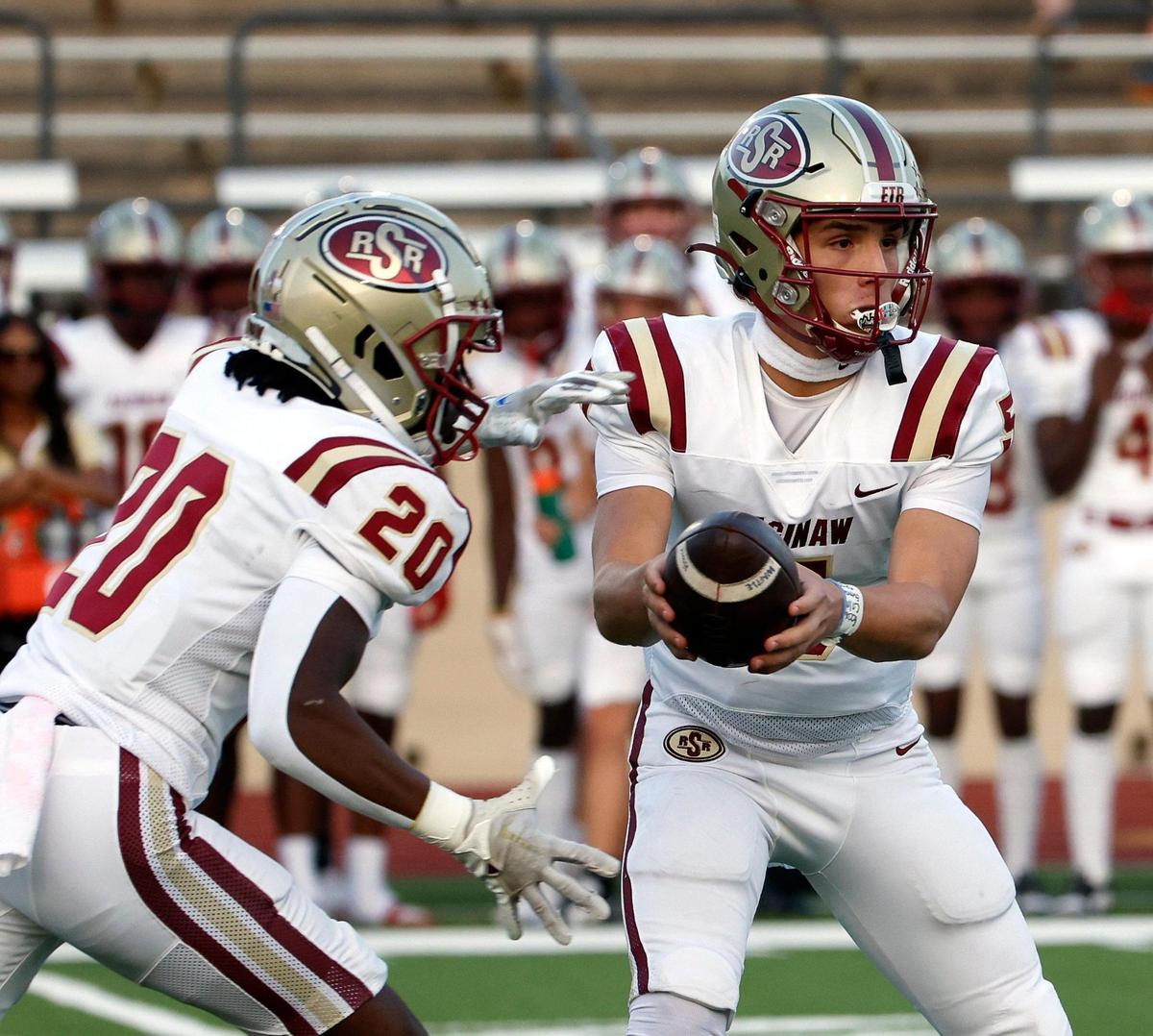 Saginaw quarterback Roman Morales (5) hands the ball to running back Roland Jackson (20) in the first half of a UIL football game at Farrington Field in Fort Worth,Texas, Friday Sept. 01, 2023. North Side led 14-7 at the half. (Special to the Star-Telegram Bob Booth)