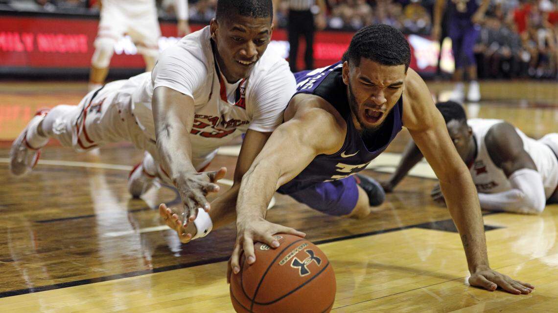 Texas Tech's Jarrett Culver and TCU's Kenrich Williams dive for a loose ball during the first half of the Red Raiders' 79-75 win over the Horned Frogs in Lubbock on Saturday, March 3.