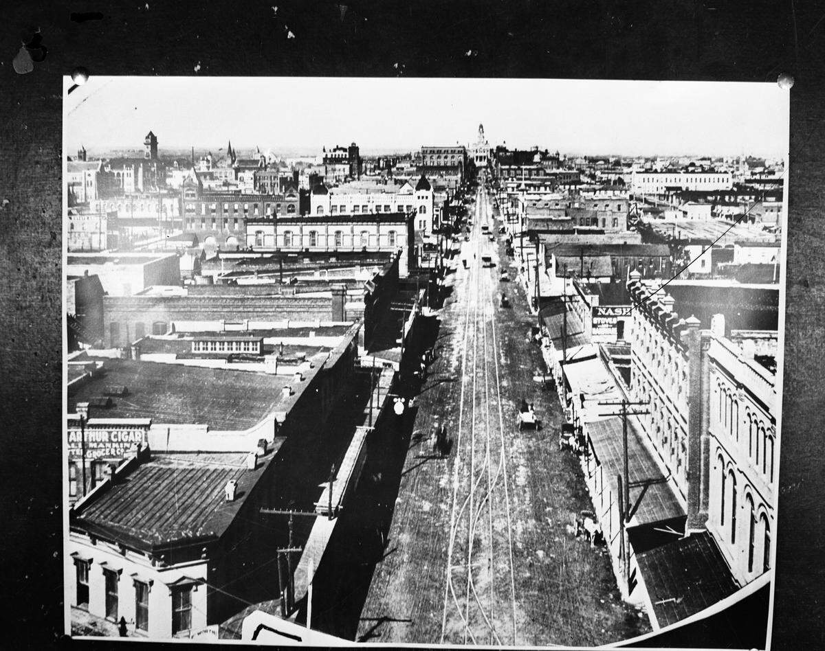 An early photograph of old Fort Worth, looking north on Main Street with the Tarrant County Courthouse at the end, from the late 1890s.