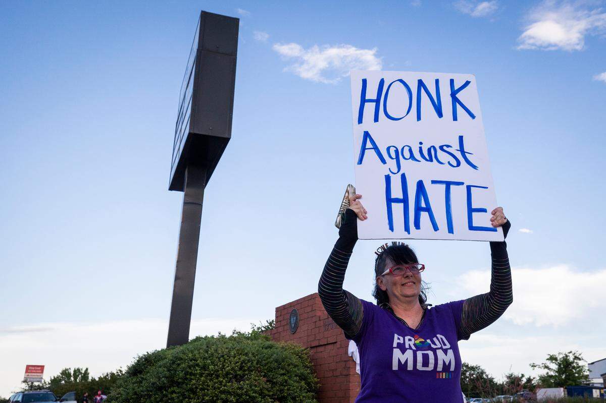 Brandy Sottilo holds up a sign near Stedfast Baptist Church where a pastor preaches against homosexuality Wednesday, June 1, 2022, in Watauga. The church had previously been ordered to vacate for inciting violence.