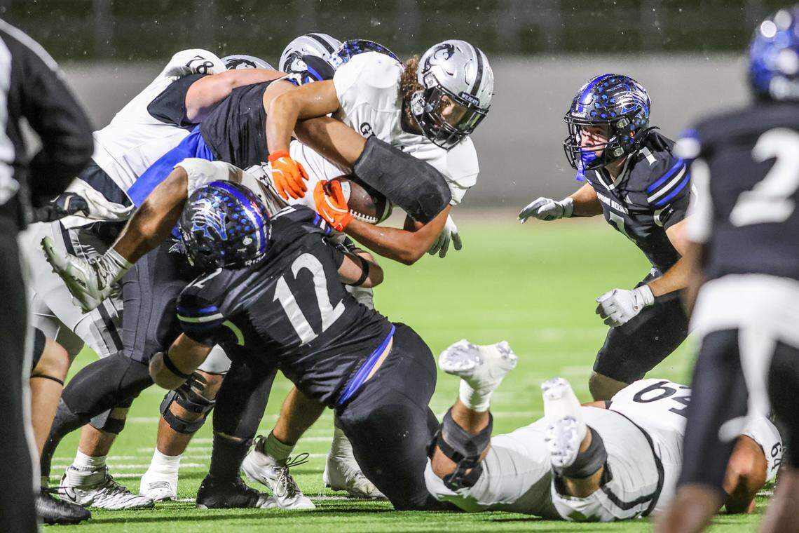 Byron Nelson’s Will Myers (12) and the Bobcat defense stop the Guyer running back for a small gain in a Class 6A Division II regional semifinal Friday, Nov. 28, 2025, at Northwest ISD Stadium in Justin, Texas.