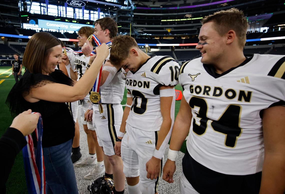 Gordon defensive end Kaden Crowe (10) receives his championship medal after winning the UIL Six-Man 1A D2 State Championship football game at AT&T Stadium in Arlington, Texas, Wednesday, Dec. 18, 2024.