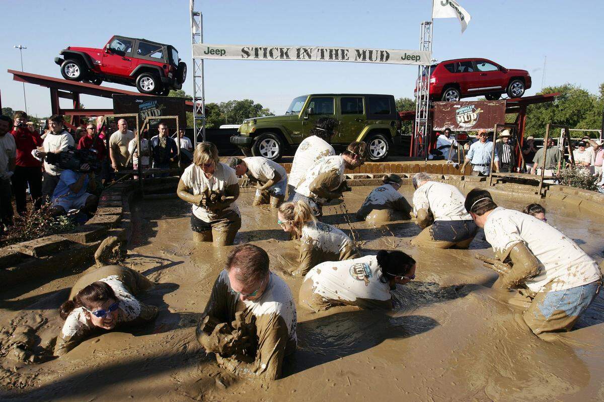 Sept. 29, 2006: A few brave mud-slingers race through a giant pool of mud at the State Fair of Texas in Dallas during the Jeep Stick in the Mud challenge for the chance to win an all-new four-door 2007 Jeep Wrangler Unlimited. Over 100 participants scoured the pool filled with 14,000 gallons of mud for hidden sticks to earn points. More than 2,600 people registered for a chance to compete.