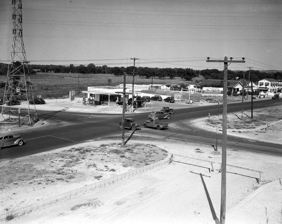 1938: Intersection of two cross-town thoroughfares, East Lancaster Avenue and Riverside Drive. This is one of the areas of high traffic accidents in Fort Worth, Texas. There are some cars in an intersection waiting to cross it.
