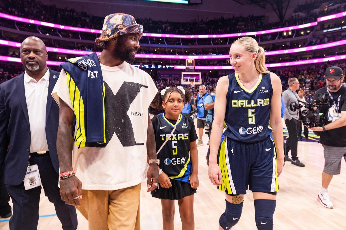 Dallas Mavericks guard Kyrie Irving, left, and Dallas Wings guard Paige Bueckers, right, greet each other following the WNBA game between the Dallas Wings and Indiana Fever at the American Airlines Center in Dallas on Friday, June 27, 2025.