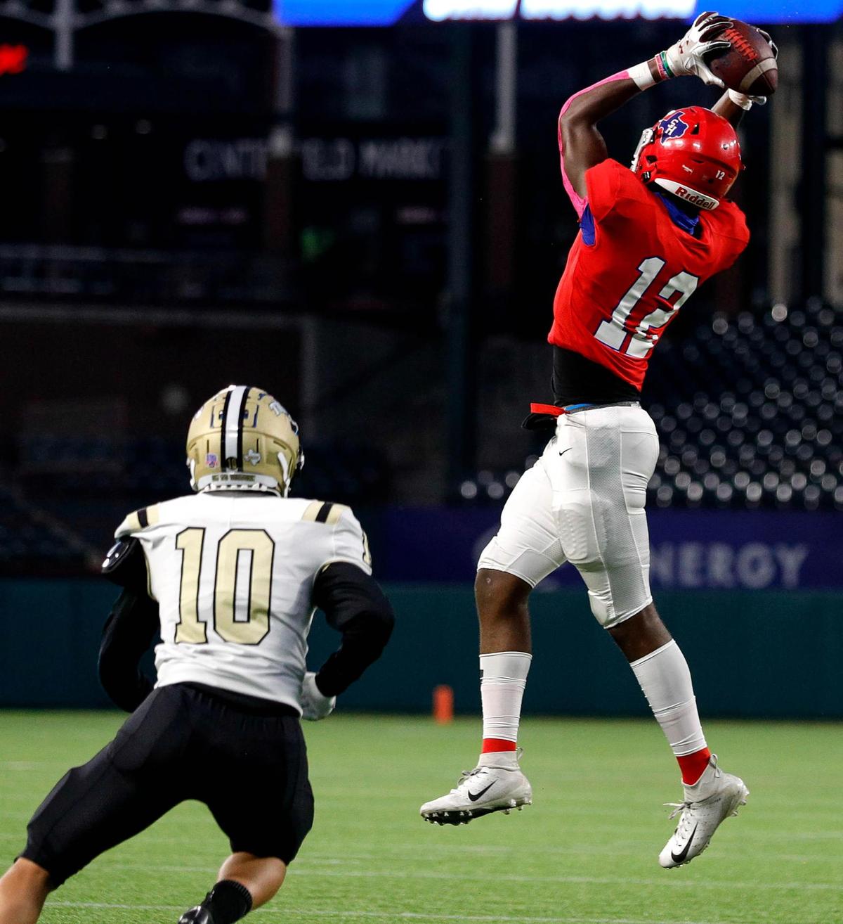 Sam Houston receiver Lafeyette Kaiuway (12) goes up to make a reception in front of Irving defensive back Anthony McAdory (10) during the first half of a High School Football game, Thursday night, October 8, 2020 played at Globe Life Park in Arlington, Tx. (Steve Nurenberg Special to the Star-Telegram)