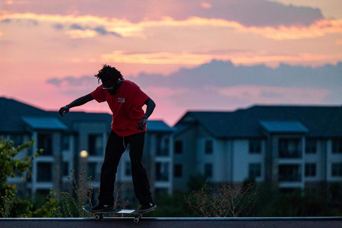 Donald Sanford balances at the top of a slope at sunset at Chisholm Trail Skate Park in Fort Worth on Tuesday, Aug. 29, 2023.