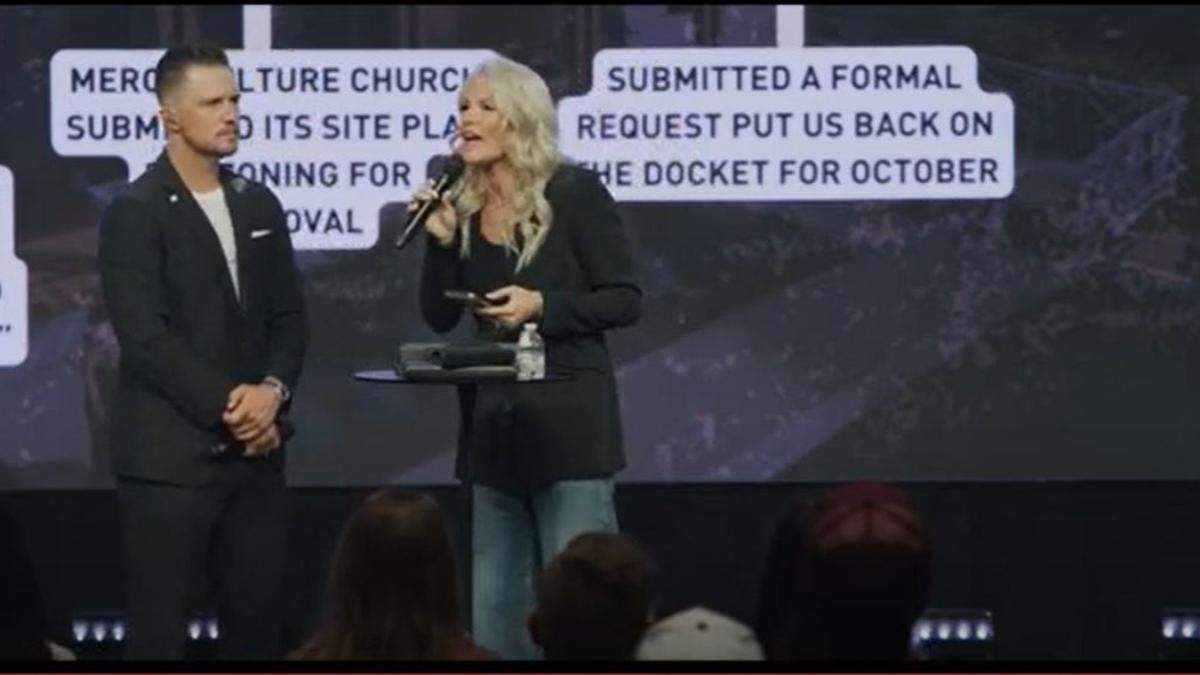 A pair of mega church pastors standing on a stage preaching