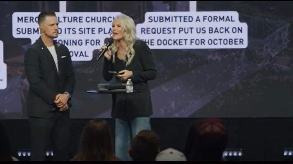 A pair of mega church pastors standing on a stage preaching