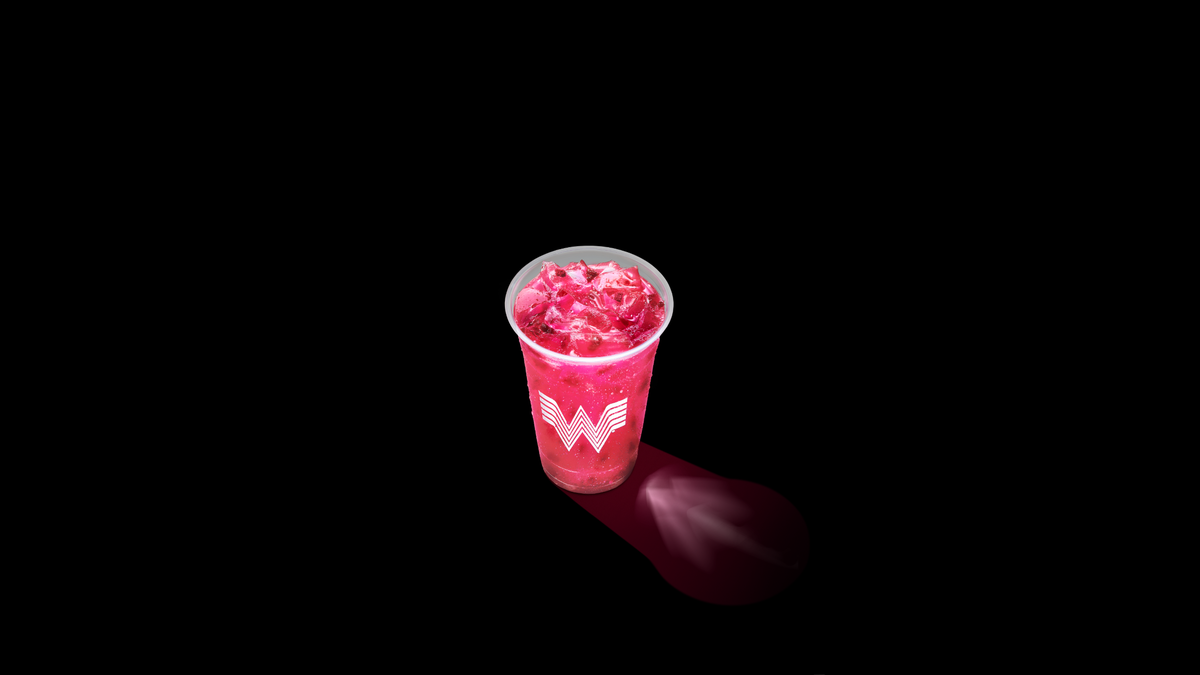 The prickly pear whatafresher. It's bright pink in a clear Whataburger cup, and it's casting a shadow next to it.