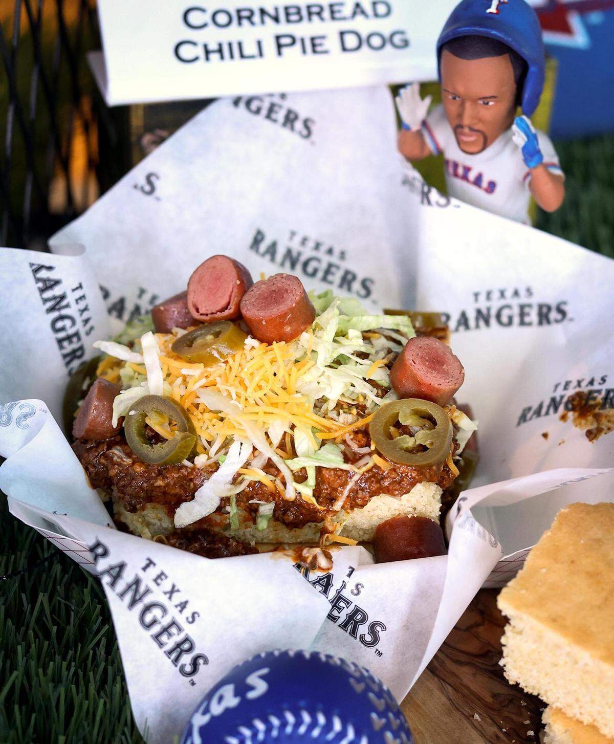 The Texas Rangers and partner Delaware North have new additions to the concessions stand items available to fans for the 2022 season at Globe Life Field. One of those items is the Cornbread Chili Pie Dog available at concession stands in Sections 132 and 225.