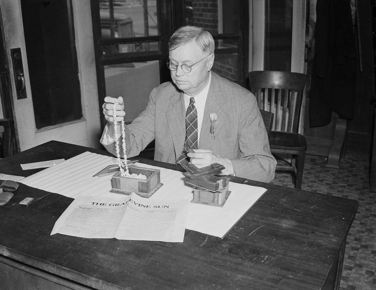 April 16, 1940: Mayor B.R. Wall of Grapevine, Texas, will be honored as his town’s No. 1 citizen on Wednesday night. He is shown in his law office, admiring one of the gifts he received - a string of beads from Pitcairn Island. A copy of the “Grapevine Sun” is displayed on his desk.