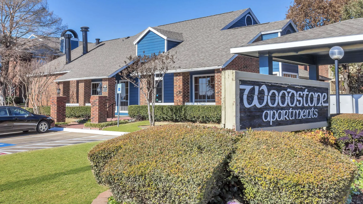 An outside view of the Woodstone Apartment complex shows the main leasing office.