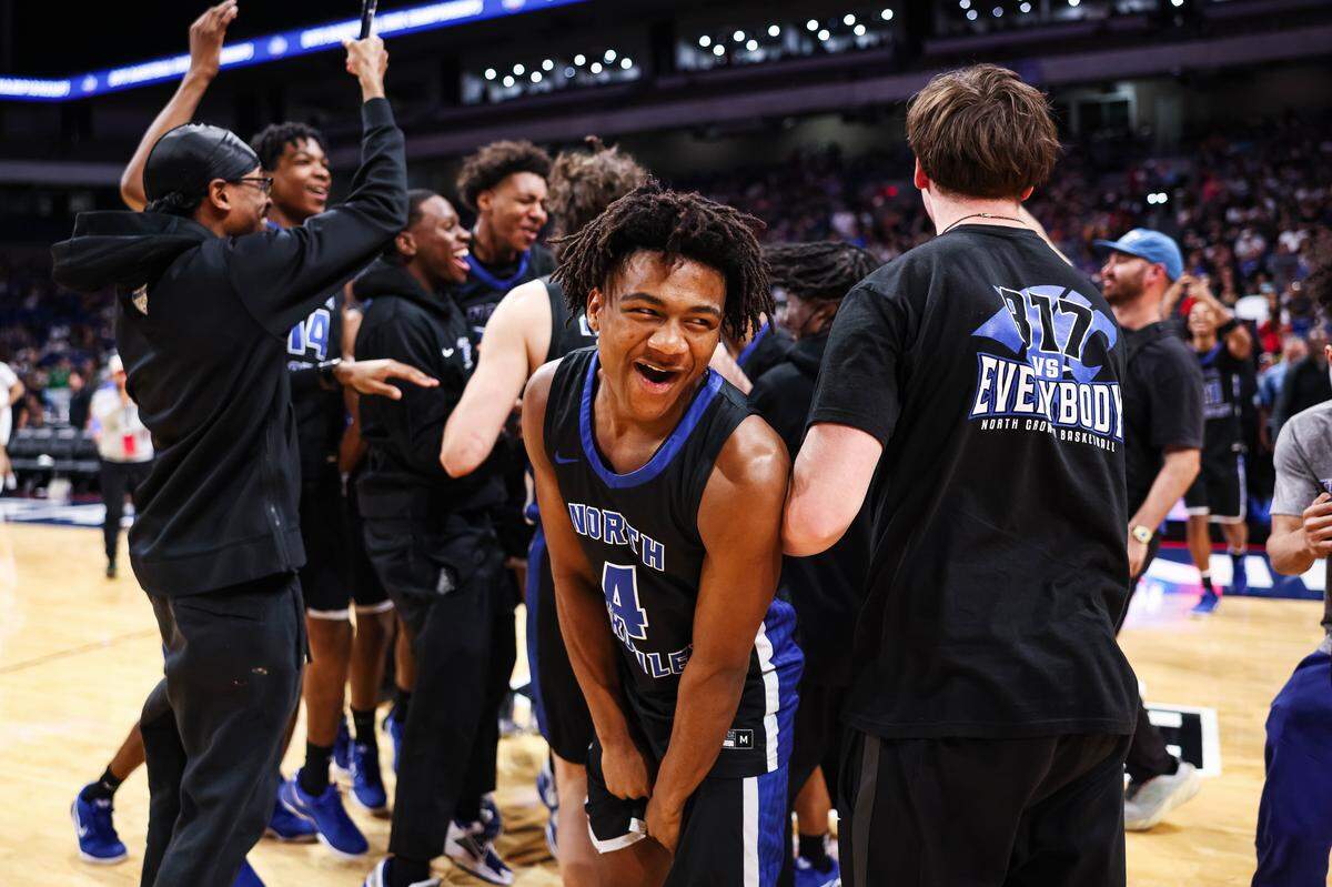 North Crowley guard Tiylyan Harris (4) celebrates as his teammates jump around after winning the Class 6A Division I state championship game against San Antonio Brennan on Saturday at the Alamodome in San Antonio.