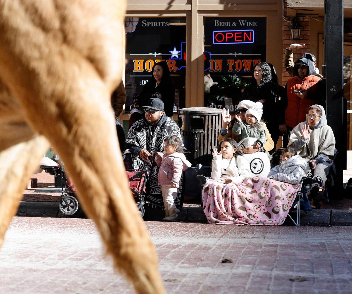 Fans bundled up and waved to the parade during the Fort Worth Stock Show and Rodeo parade in Fort Worth, Texas, Saturday, Jan, 13, 2024. Temperature as the parade stepped off was 42. (Special to the Star-Telegram Bob Booth)