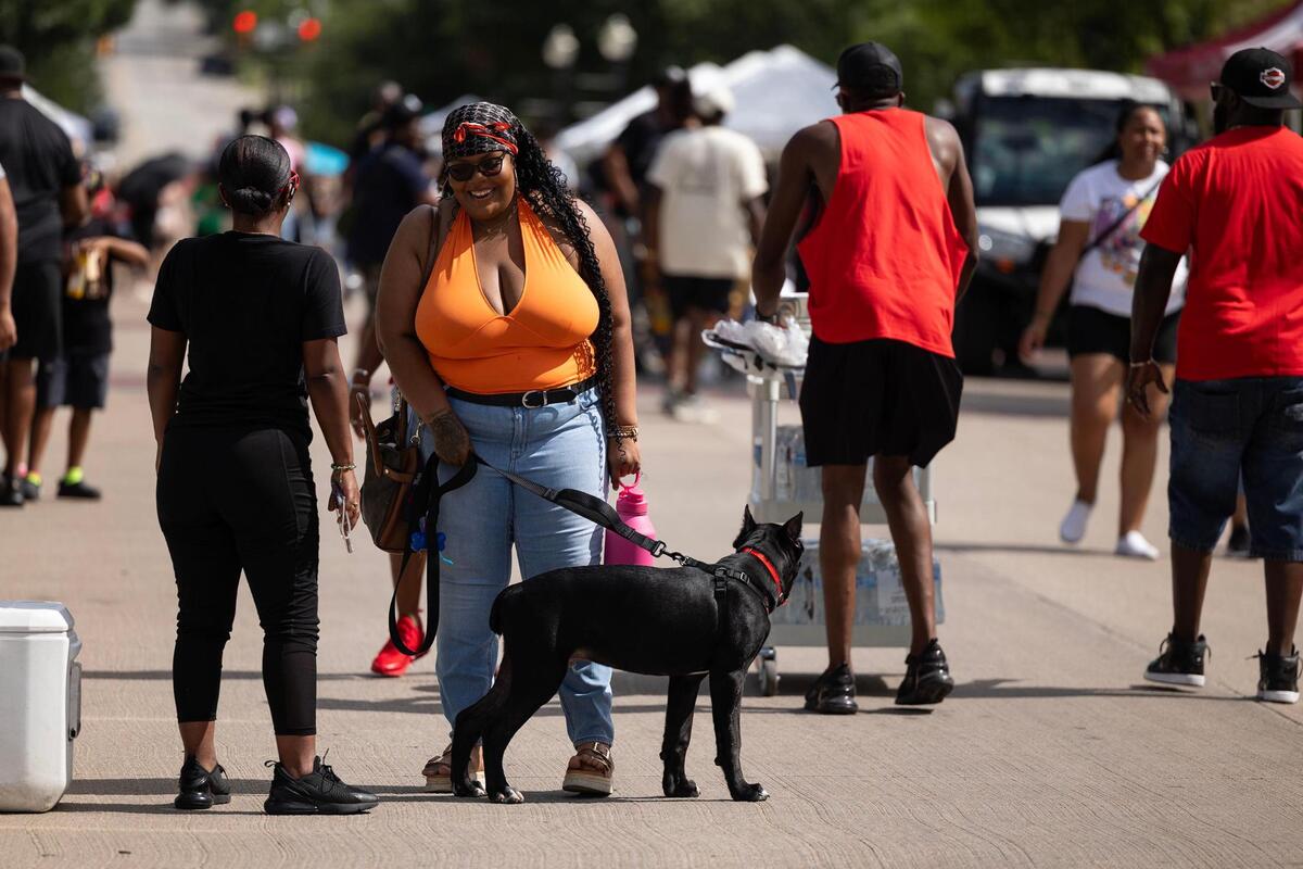 Event attendees walk down Evans Avenue for the Freedom Vibes Juneteenth Block Party in Fort Worth on Saturday, June 21, 2025.