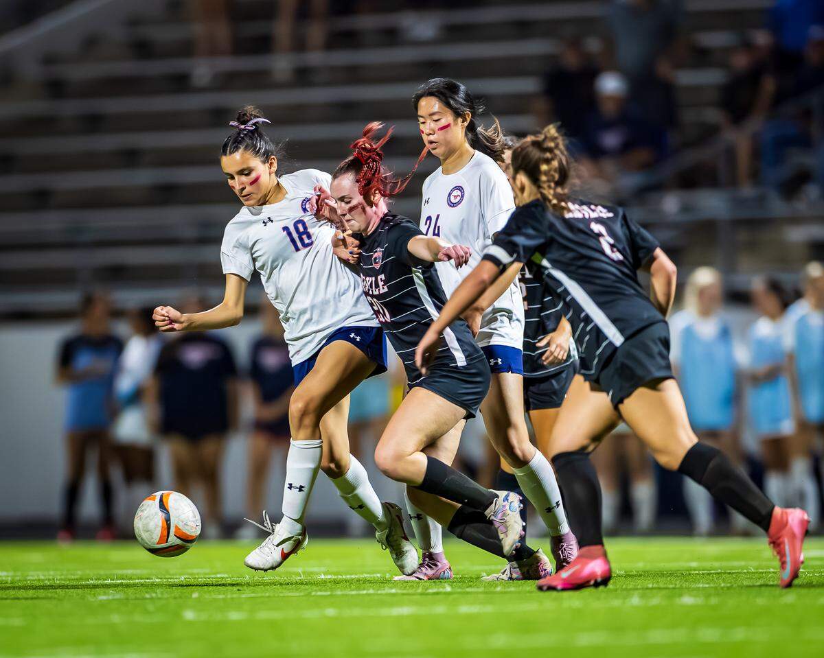 Grapevine’s Genesis Alvarenga (18) and Eugenia Jin (24) battle with Argyle defenders in the Class 5A Division 2 Region 1 Final soccer match on Tuesday, March 31, 2026, at Northwest ISD Stadium in Justin, Texas.