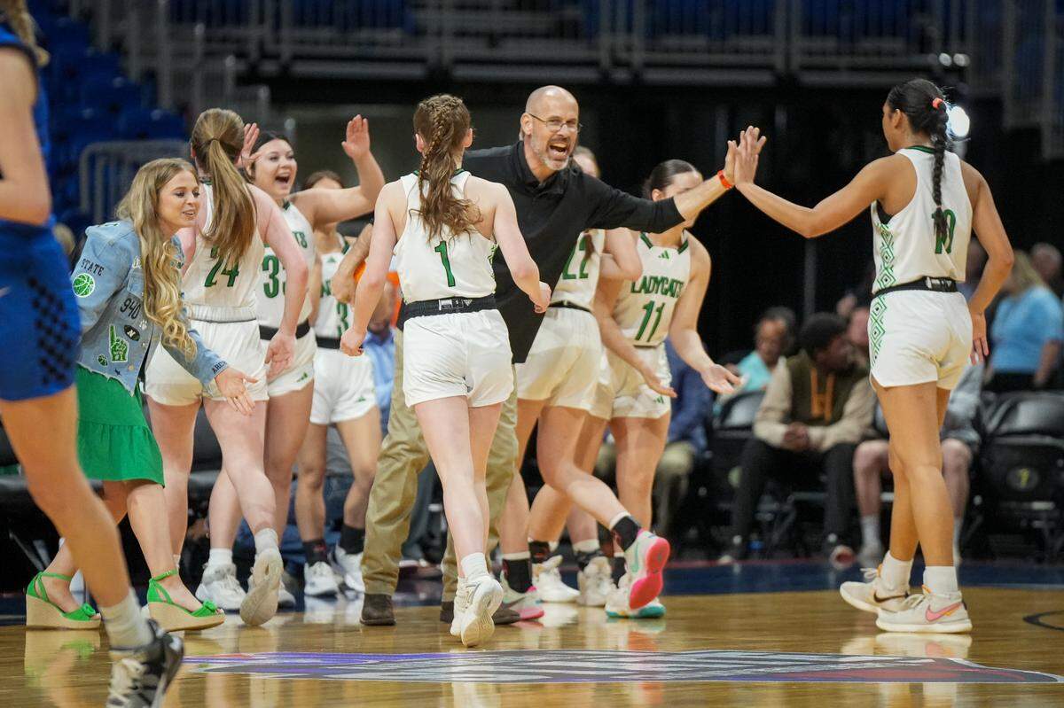 Newcastle coach Ryan Dollar celebrates with his team during a time out. Newcastle defeated Westbrook 59-37 in a Class 1A state semifinal on Thursday, February 29, 2024 at the Alamodome in San Antonio, Texas.